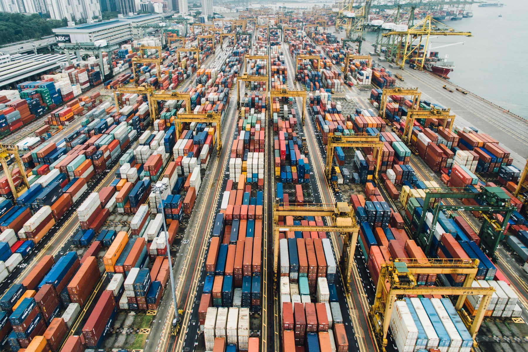 Aerial view of shipping containers and cranes at a cargo port